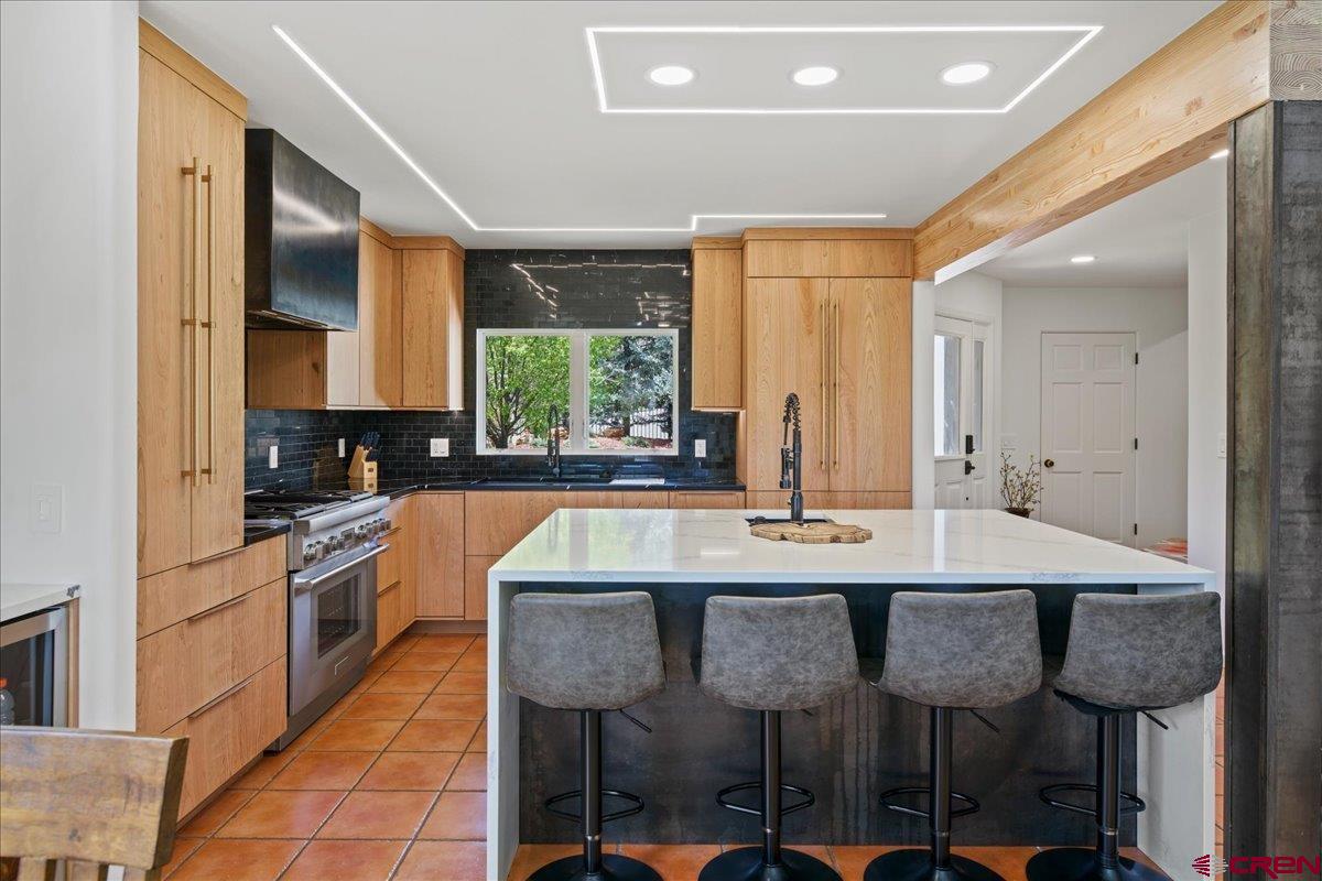 320 South Amelia Street Ridgway, CO 81432 - Photo 14 of 40 a kitchen with kitchen island granite countertop a table chairs sink and cabinets