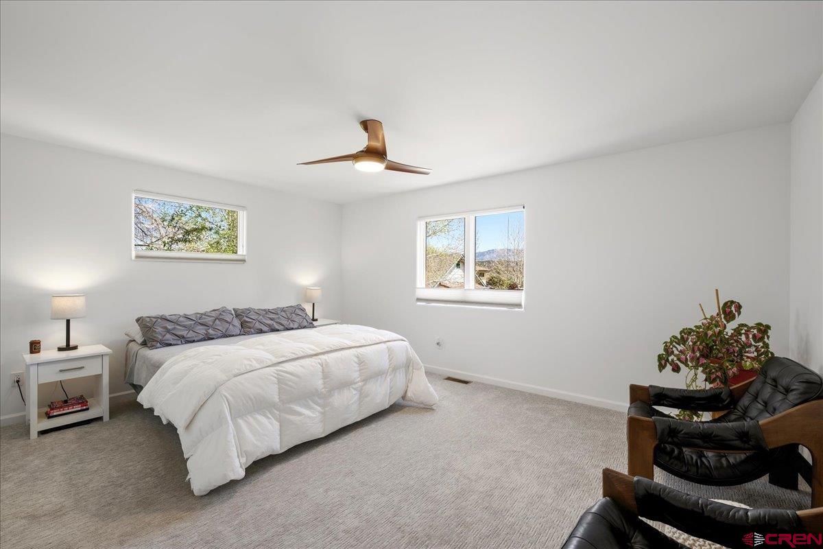 320 South Amelia Street Ridgway, CO 81432 - Photo 15 of 40 a bedroom with a bed and a chandelier