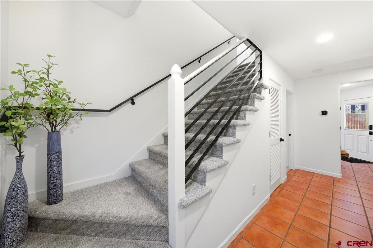 320 South Amelia Street Ridgway, CO 81432 - Photo 20 of 40 a view of staircase with white walls and a potted plant