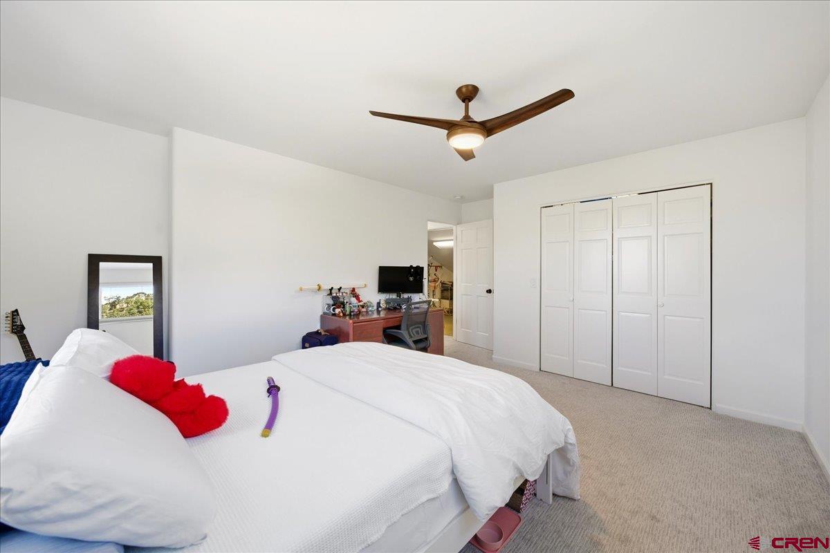 320 South Amelia Street Ridgway, CO 81432 - Photo 22 of 40 a bedroom with a bed and a ceiling fan