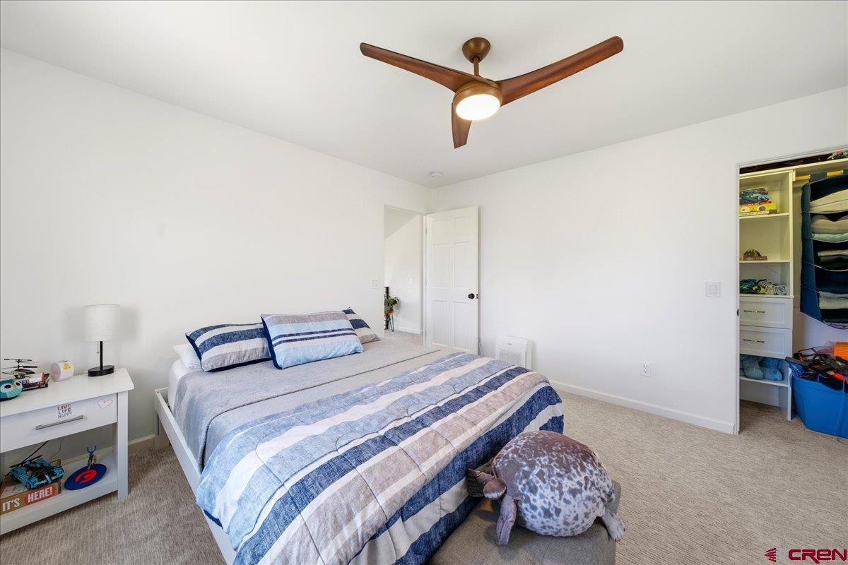 320 South Amelia Street Ridgway, CO 81432 - Photo 25 of 40 a bedroom with a bed and a chandelier