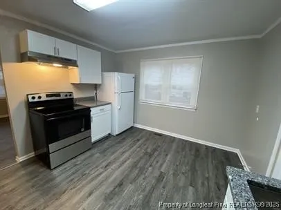 a kitchen with wooden floors and appliances