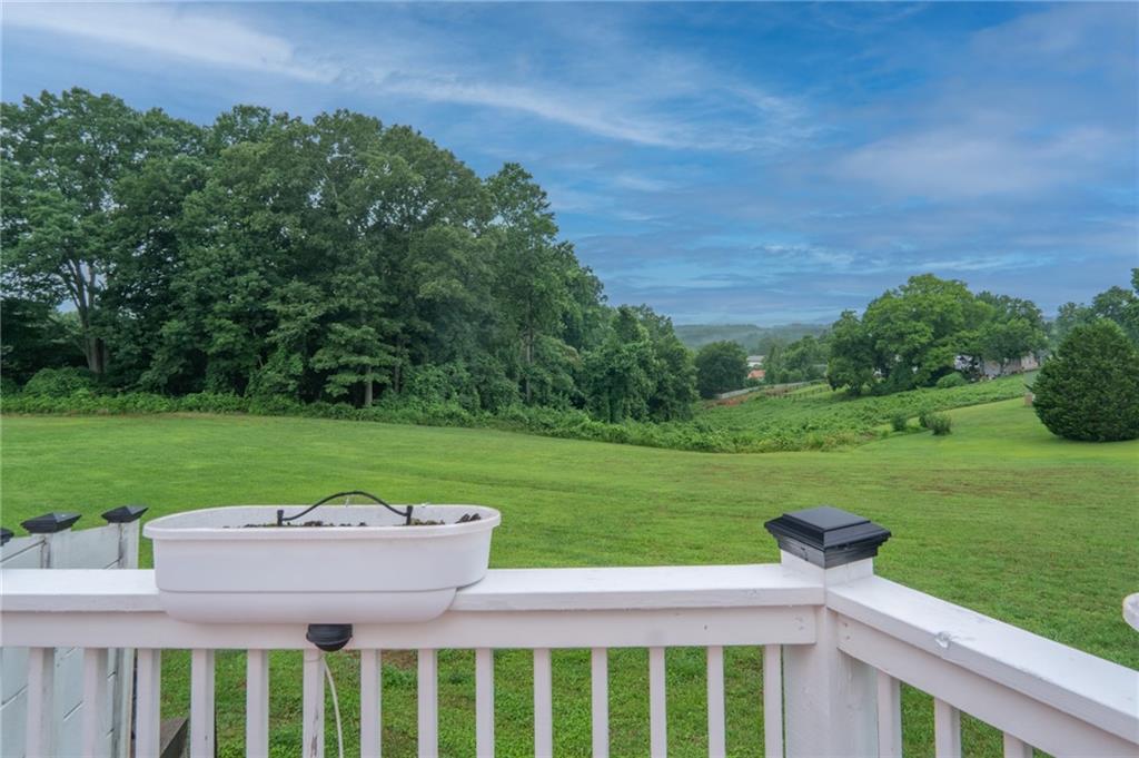 1815 Pickens Street Ball Ground, GA 30107 - Photo 27 of 38 a view of a wooden deck and a yard