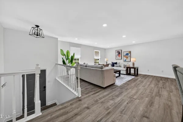 a living room with furniture and a wooden floor