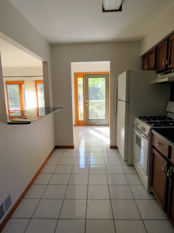 304 Ralph Court Island Lake, IL 60042 - Photo 4 of 16 a kitchen with granite countertop a stove a sink and a refrigerator