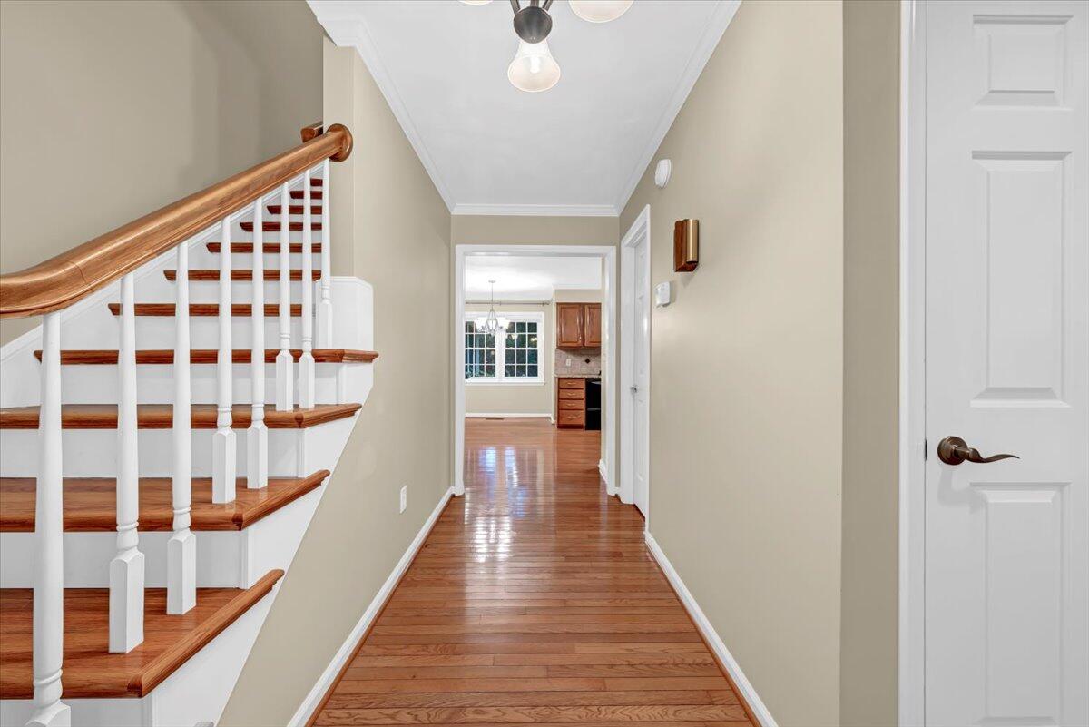 278 Stonehaven Lane Blue Ridge, VA 24064 - Photo 7 of 61 a view of a hallway with wooden floor and staircase