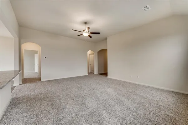 a view of a livingroom with a ceiling fan and window