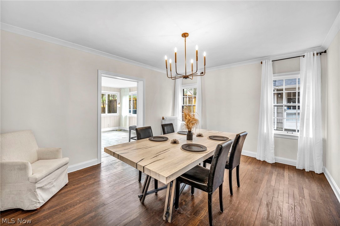 17409 Fernway Road Cleveland, OH 44120 - Photo 11 of 47 Dining space with dark hardwood / wood-style flooring, crown molding, and a notable chandelier
