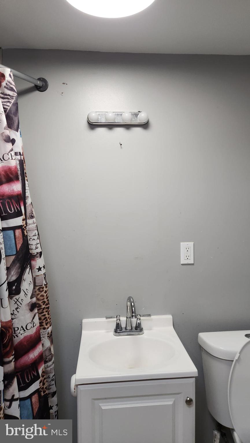 1024 Wicklow Road Baltimore, MD 21229 - Photo 44 of 44 a bathroom with a sink toilet and vanity
