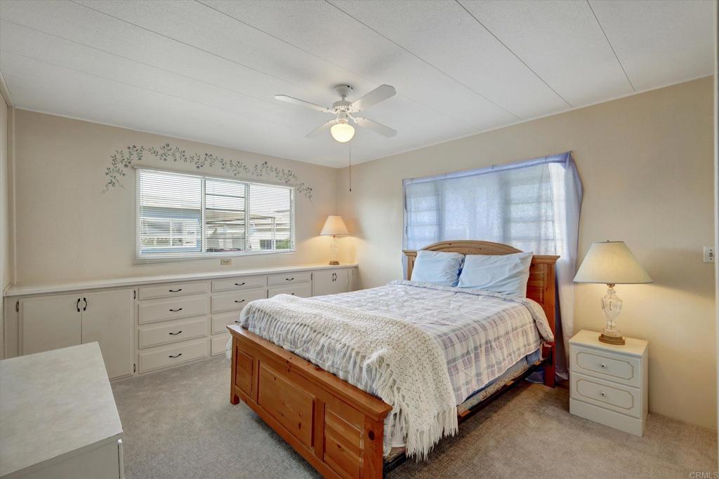 287 Robin Lane Oceanside, CA 92057 - Photo 17 of 27 a bedroom with a bed and a window