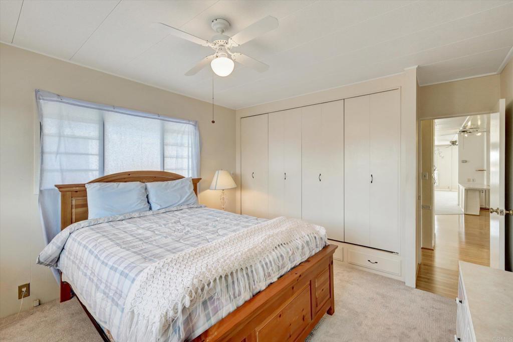 287 Robin Lane Oceanside, CA 92057 - Photo 18 of 27 a bedroom with a bed and a chandelier