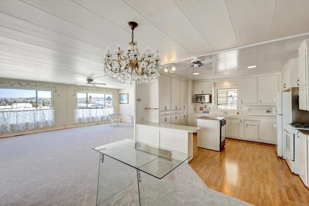 287 Robin Lane Oceanside, CA 92057 - Photo 6 of 27 a view of a dining room with furniture a chandelier and wooden floor