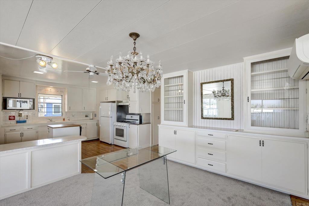 287 Robin Lane Oceanside, CA 92057 - Photo 7 of 27 a living room with kitchen island granite countertop furniture and a chandelier
