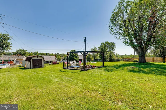 a view of a house with swimming pool and sitting area