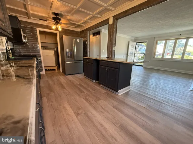 a view of a refrigerator in kitchen and wooden floor