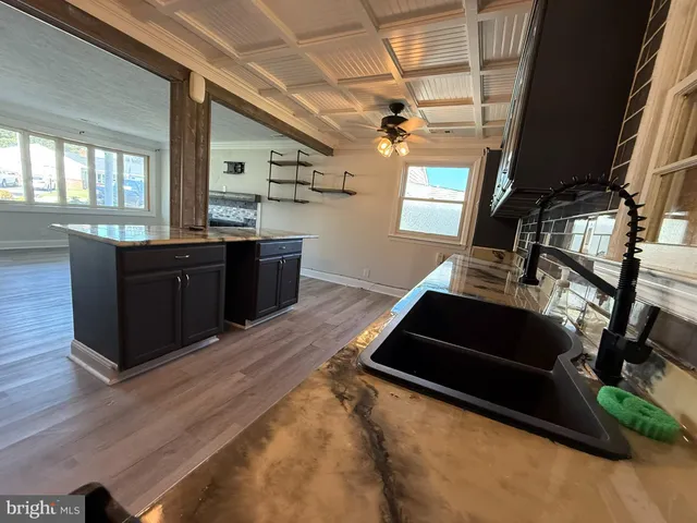 a living room with wooden floor furniture and a window