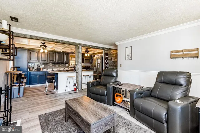 a living room with furniture and a kitchen view