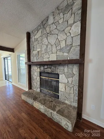 a view of an empty room with a ceiling fan and a window