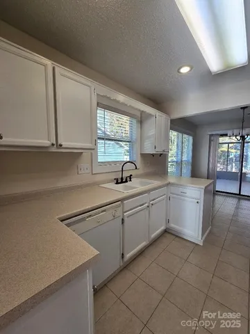 a kitchen with a sink cabinets and window