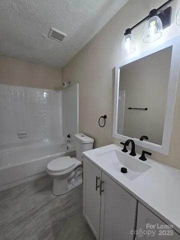 a bathroom with a sink toilet and mirror