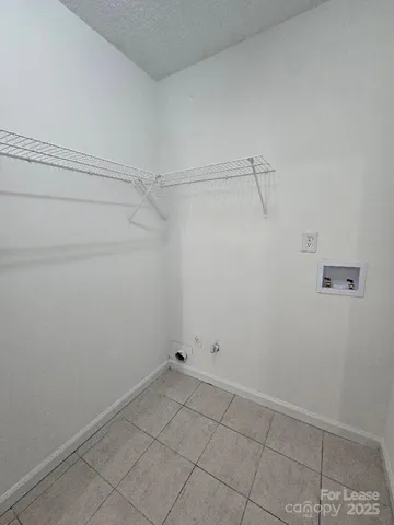 a view of a room with window and a ceiling fan