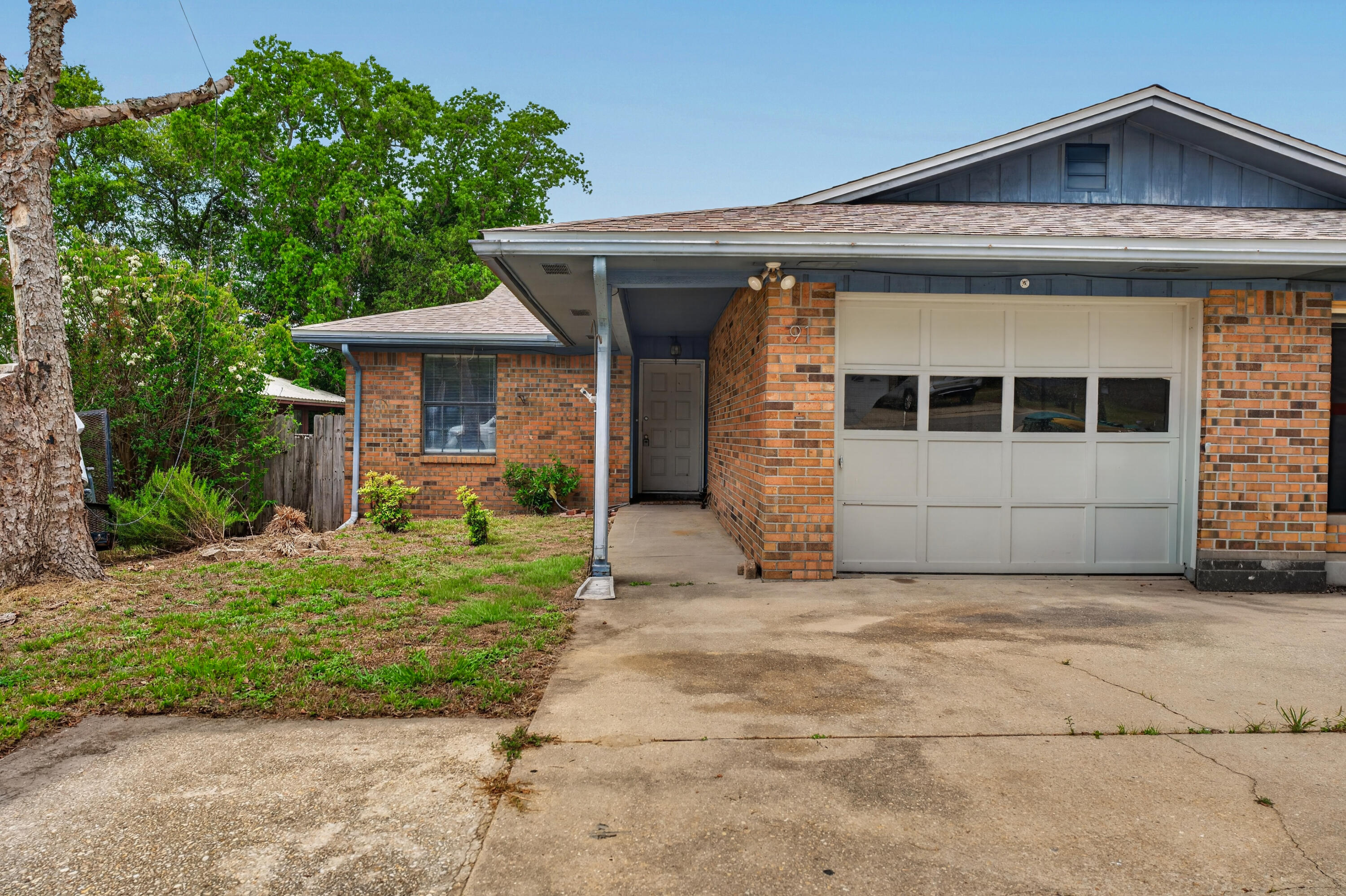 91 Catamaran Lane Shalimar, FL 32579 - Photo 1 of 24 a view of a house with a garage and a yard