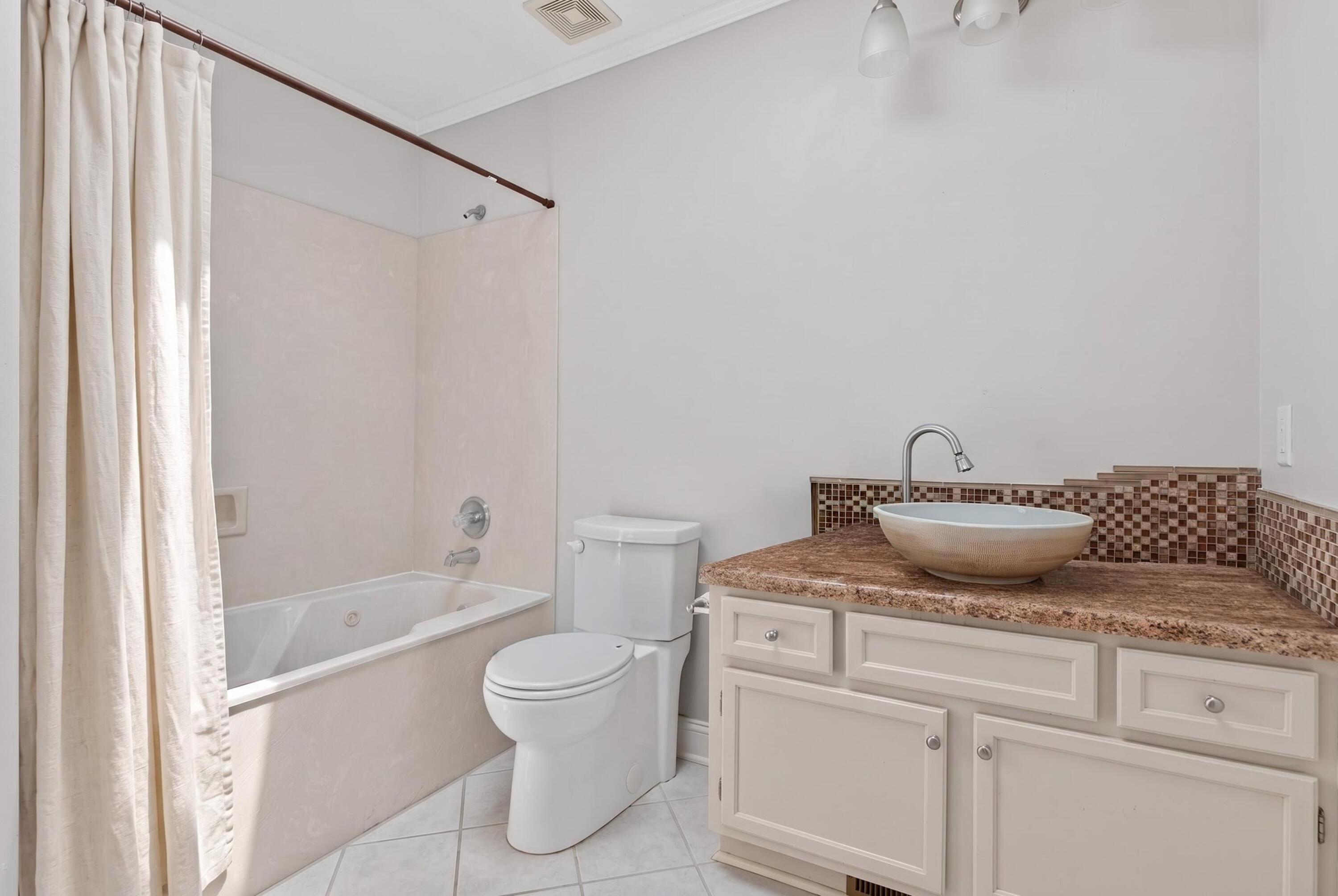 91 Catamaran Lane Shalimar, FL 32579 - Photo 16 of 24 a bathroom with a granite countertop bathtub sink vanity mirror and toilet