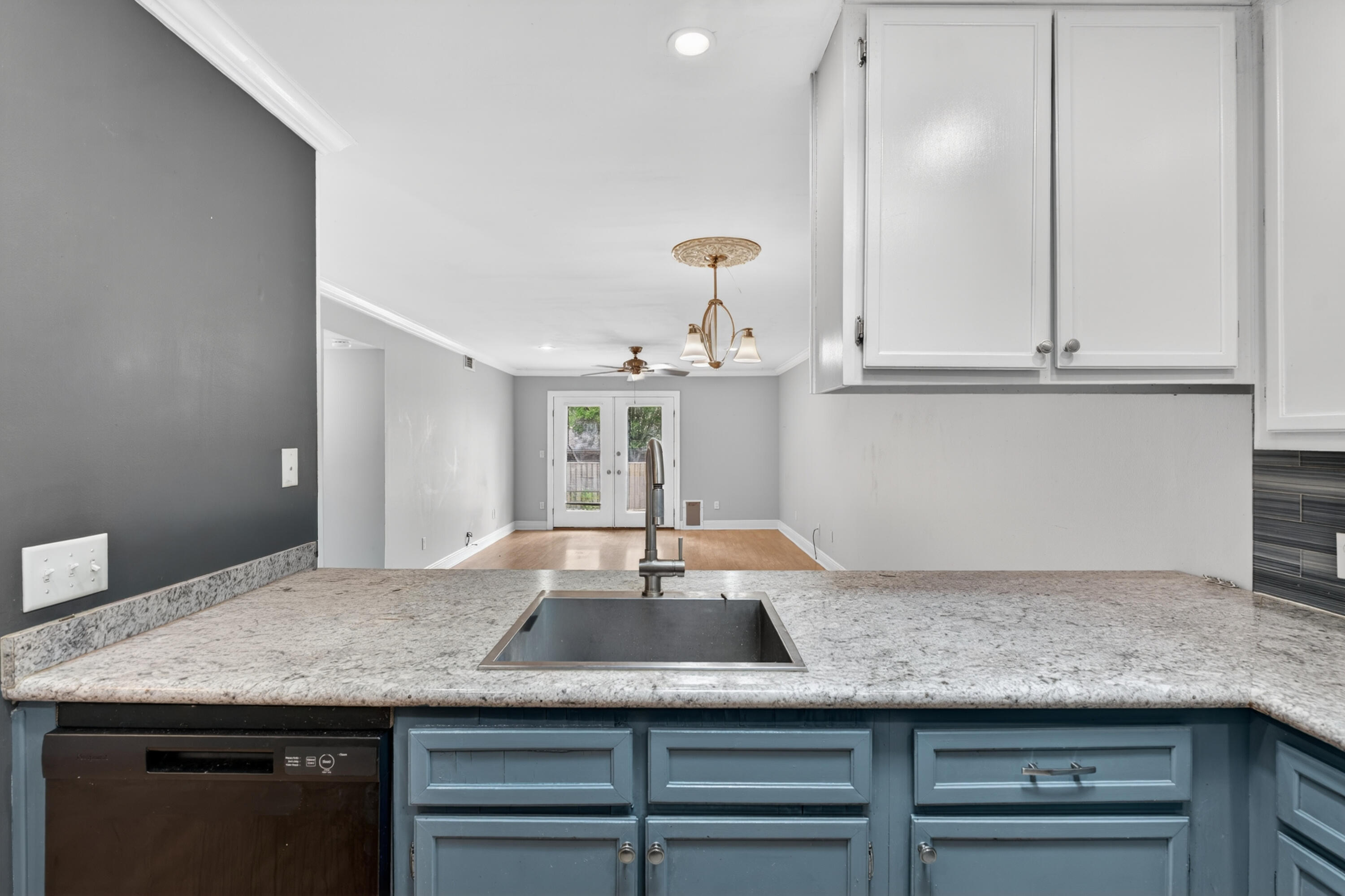 91 Catamaran Lane Shalimar, FL 32579 - Photo 8 of 24 a kitchen with cabinets granite counter tops and a wooden floor