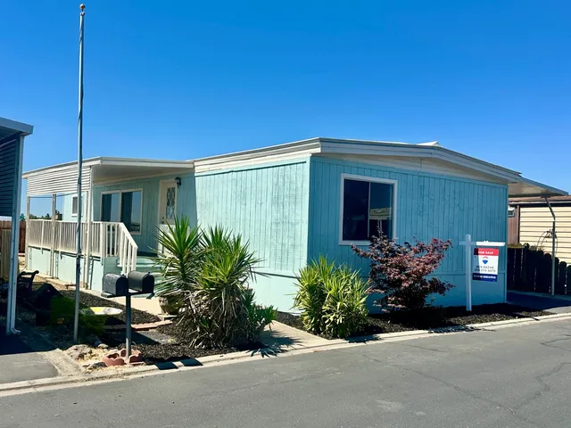 front view of a house with potted plants
