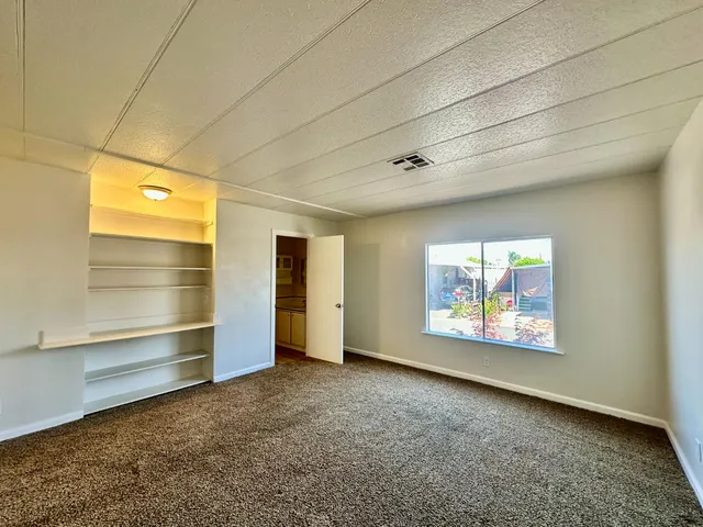 a view of an empty room with a window