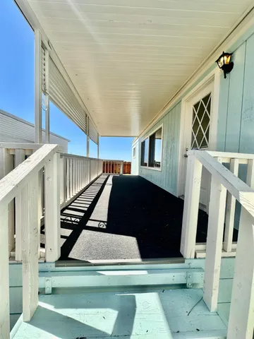 a view of entryway bedroom and hall with wooden floor