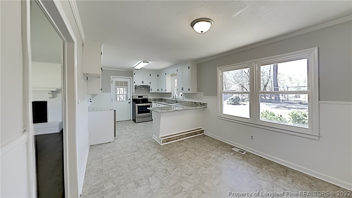 2753 Wade-Stedman Road Stedman, NC 28391 - Photo 3 of 15 a kitchen with white cabinets and a refrigerator