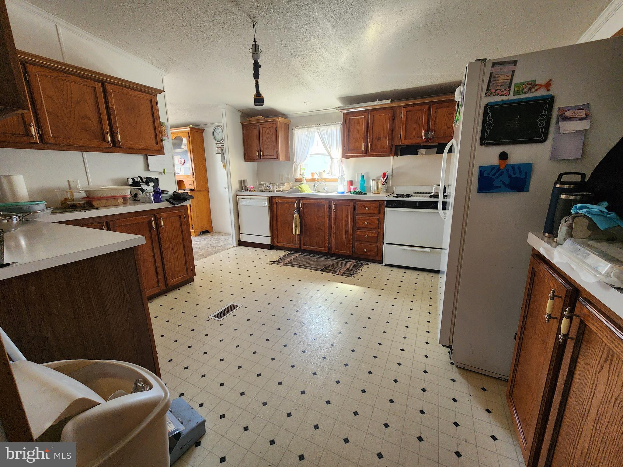 1337 Tower Road Camden Wyoming, DE 19934 - Photo 31 of 41 a kitchen with stainless steel appliances a refrigerator a sink a stove a microwave and wooden cabinets