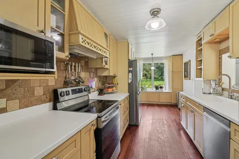 a kitchen with stainless steel appliances granite countertop a stove and a sink