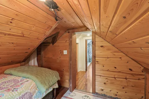 a bedroom with a bed next to a large window