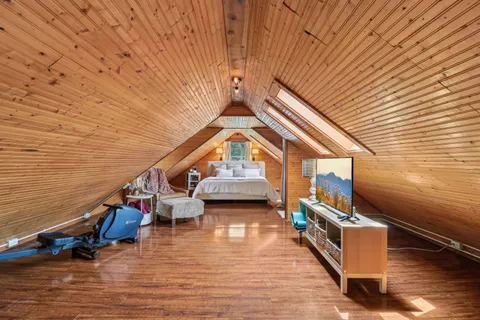 a view of living room with furniture and wooden floor
