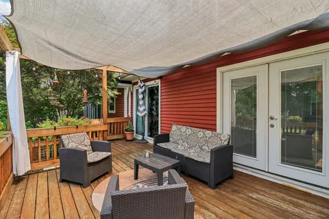 a view of a swimming pool with a patio and a yard
