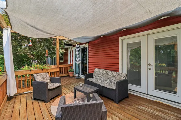 a view of a swimming pool with a patio and a yard