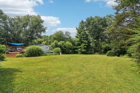 a front view of house with yard and trees