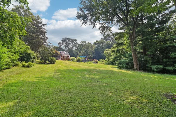 a front view of a house with yard and green space