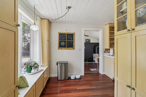 a large kitchen with a lot of counter space and wooden floor