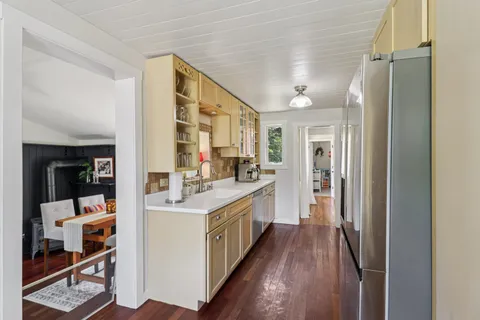 a kitchen with stainless steel appliances granite countertop a refrigerator and a sink