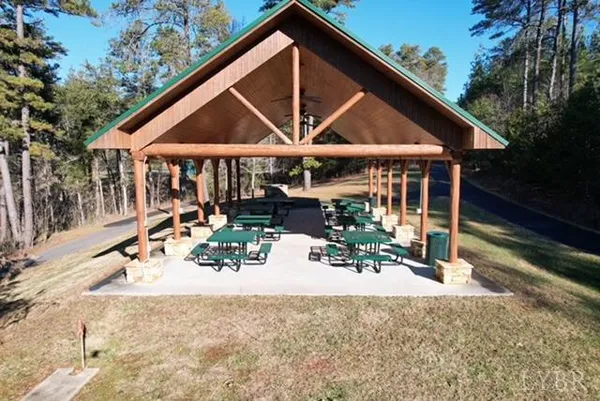 a view of a house with backyard and sitting area