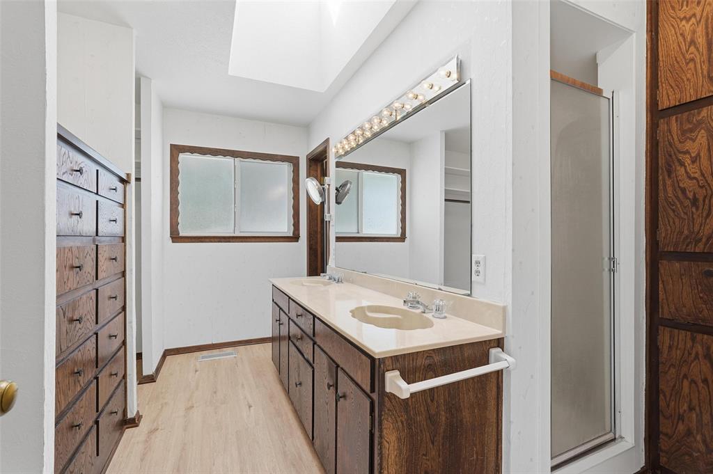 112 Virginia Lane Arlington, TX 76010 - Photo 20 of 39 a bathroom with a sink a vanity and a mirror