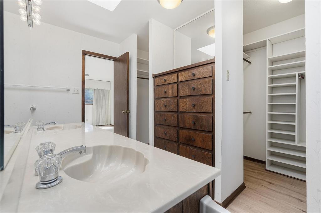 112 Virginia Lane Arlington, TX 76010 - Photo 21 of 39 a bathroom with a sink a vanity and shower