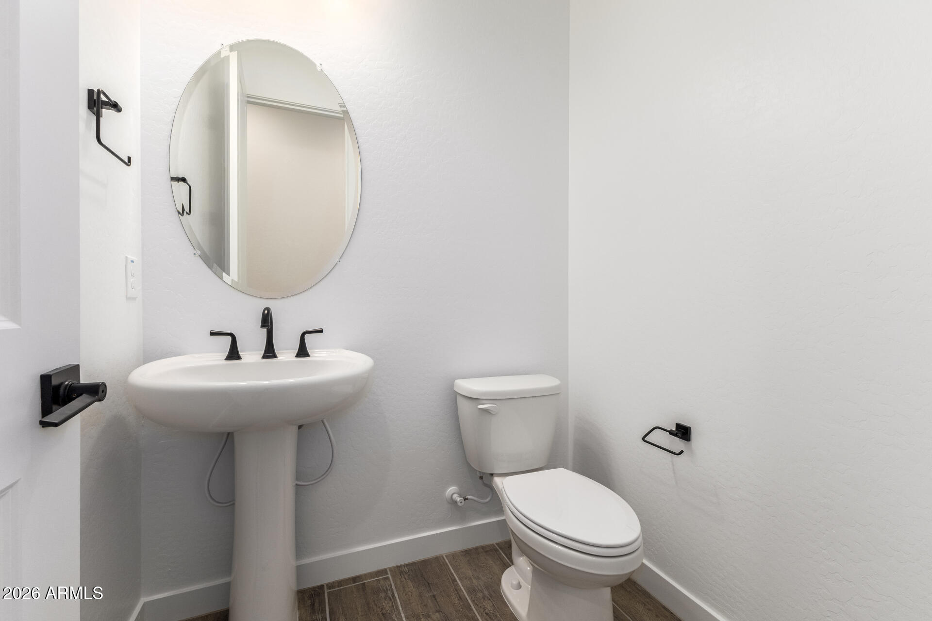 18146 West Watkins Street Goodyear, AZ 85338 - Photo 12 of 36 a bathroom with a toilet sink and mirror