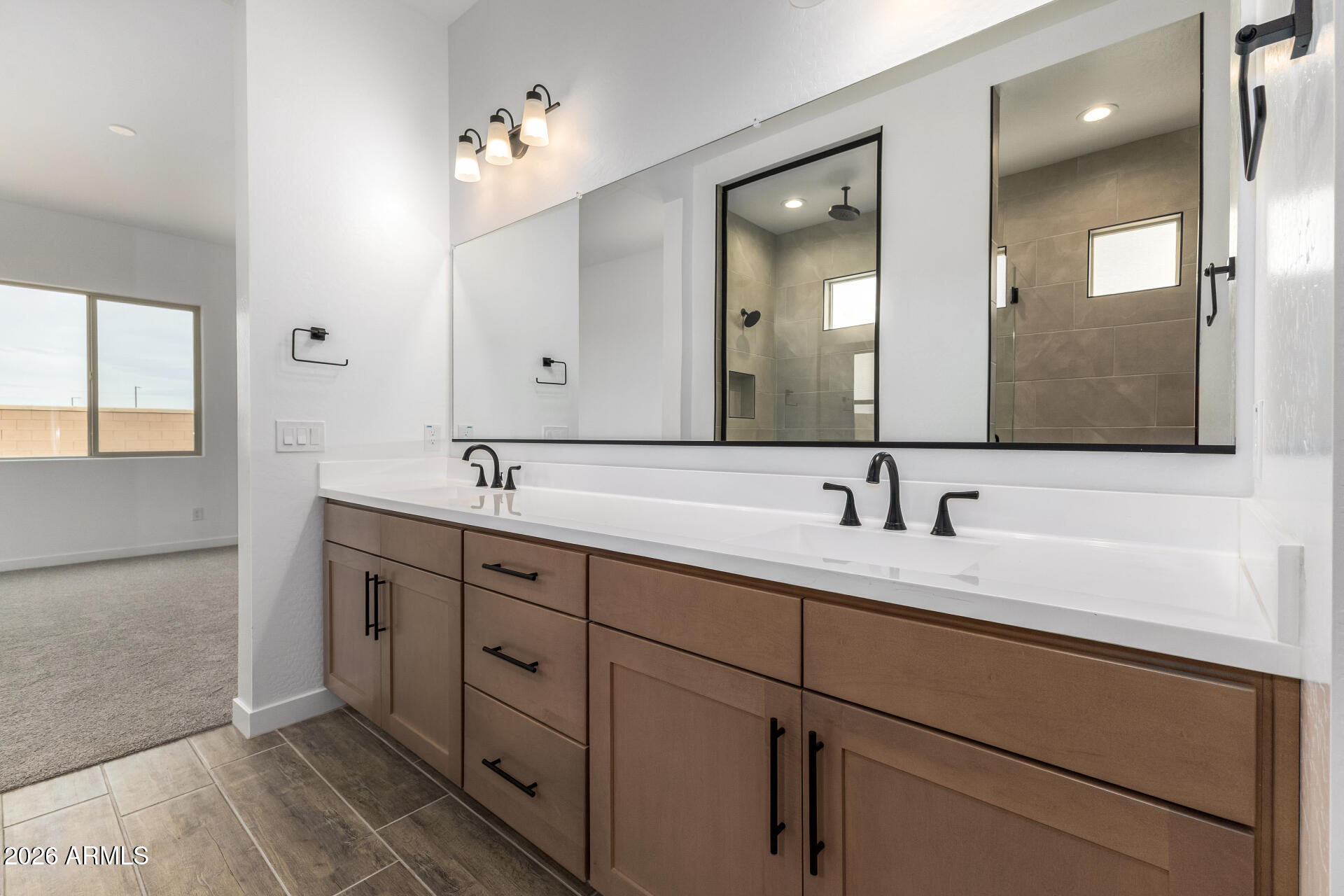18146 West Watkins Street Goodyear, AZ 85338 - Photo 16 of 36 a bathroom with double sink and a mirror
