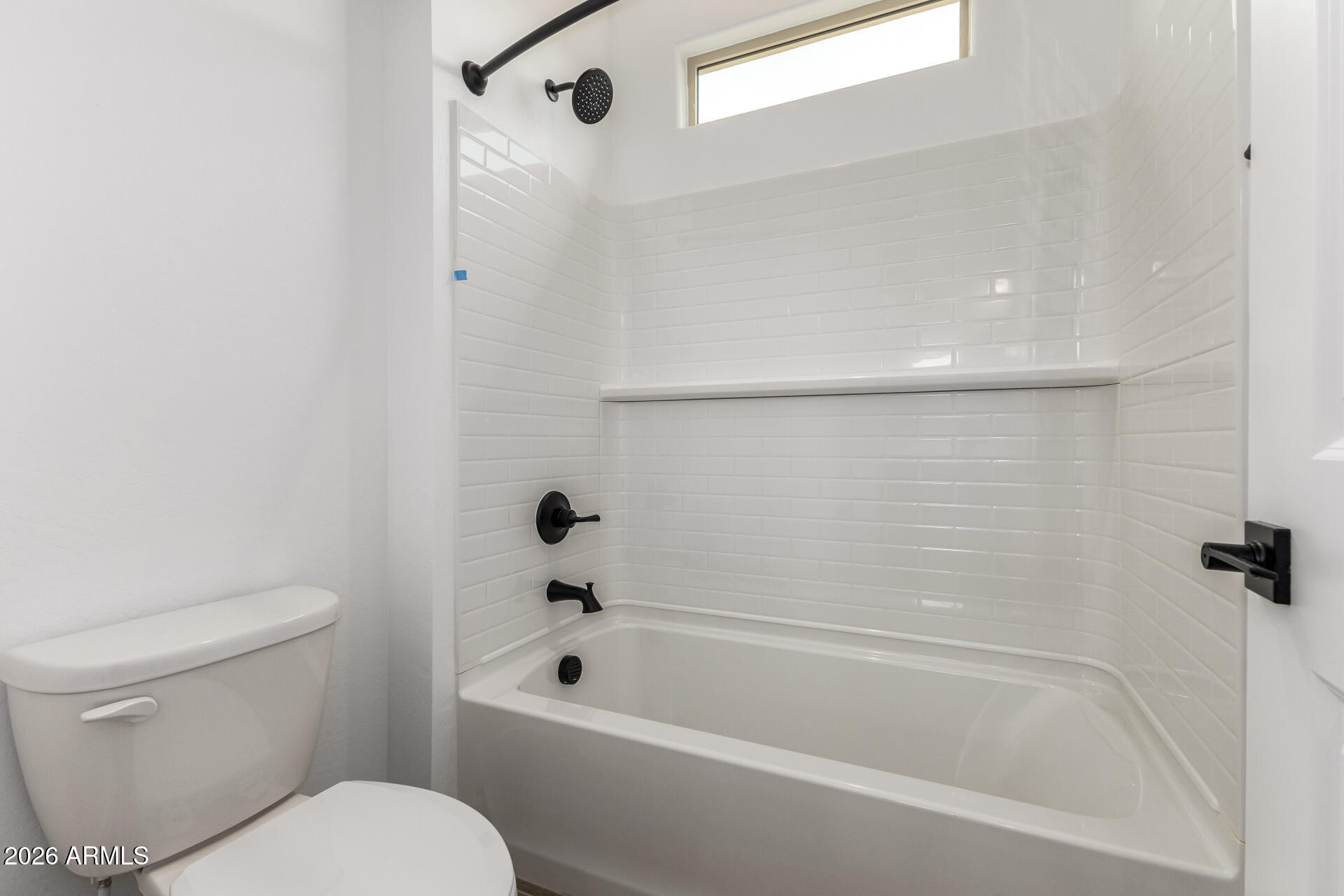 18146 West Watkins Street Goodyear, AZ 85338 - Photo 22 of 36 a white bath tub sitting next to a toilet