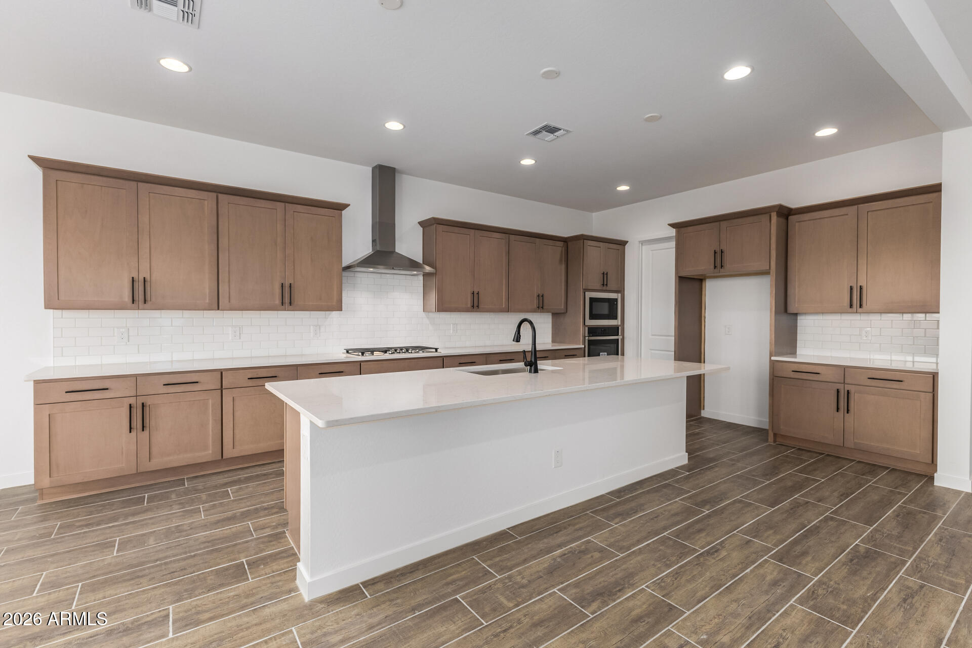 18146 West Watkins Street Goodyear, AZ 85338 - Photo 2 of 36 a large white kitchen with cabinets