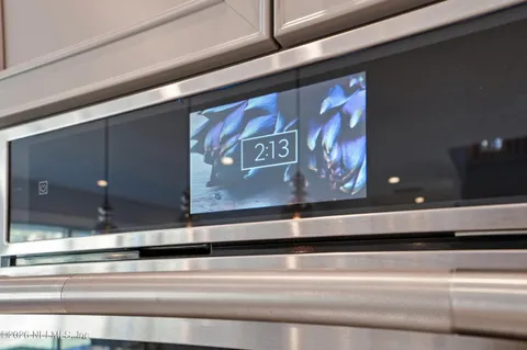 a spacious bedroom with a large bed and a chandelier